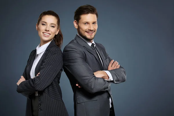 Business couple on blue background — Stock Photo, Image