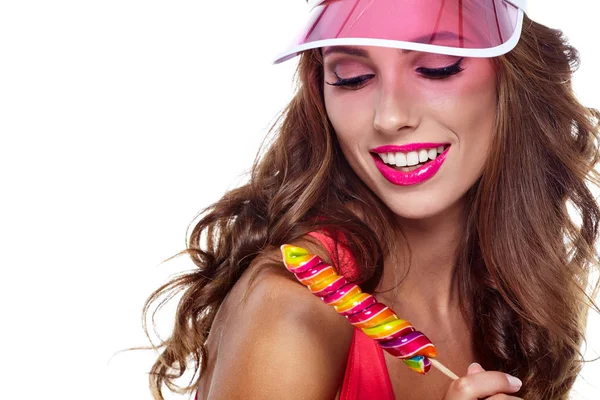 Girl wearing plastic cap holding lollipop — Stock Photo, Image