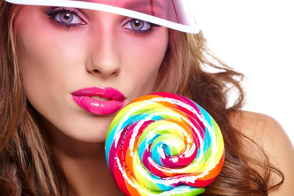 Girl wearing plastic cap holding lollipop — Stock Photo, Image