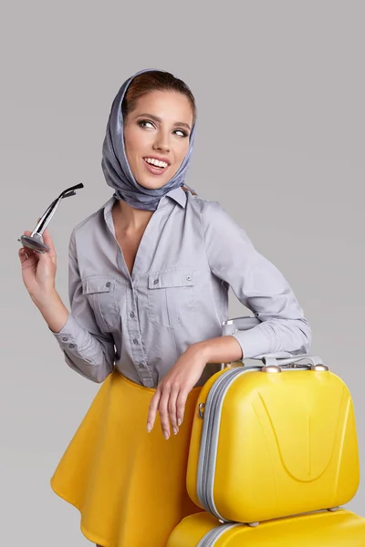 Mujer glamour con paraguas amarillo y maleta. Concepto de viaje — Foto de Stock