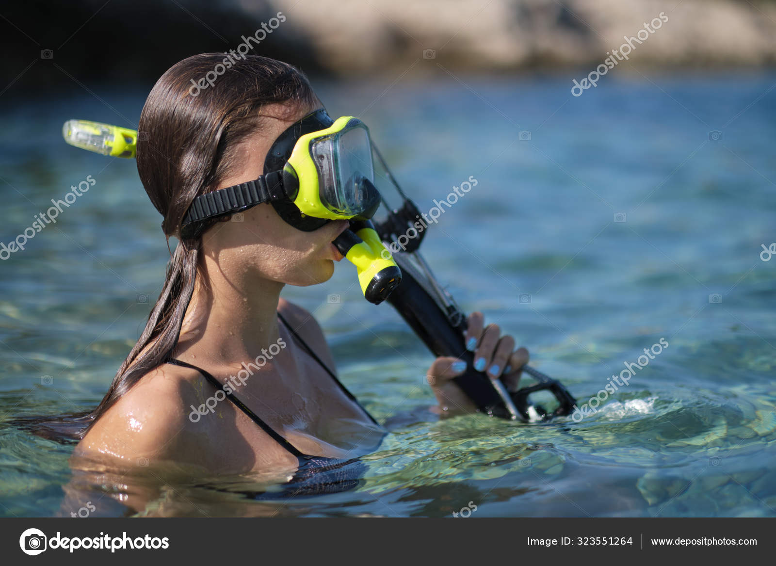 Aqua woman diver spearfishing gun. Stock Photo by ©zoomteam 323551264