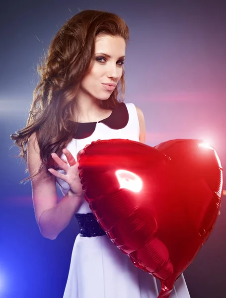 Beautiful woman with air balloon like heart — Stock Photo, Image