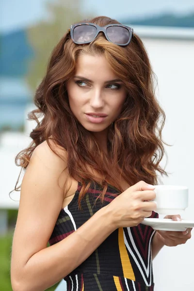 Woman drinking coffee in hotel terrace over sea view — Stock Photo, Image