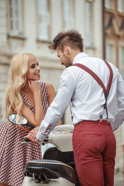 Romantic couple with motorcycle. Loving couple riding on motor in the city.