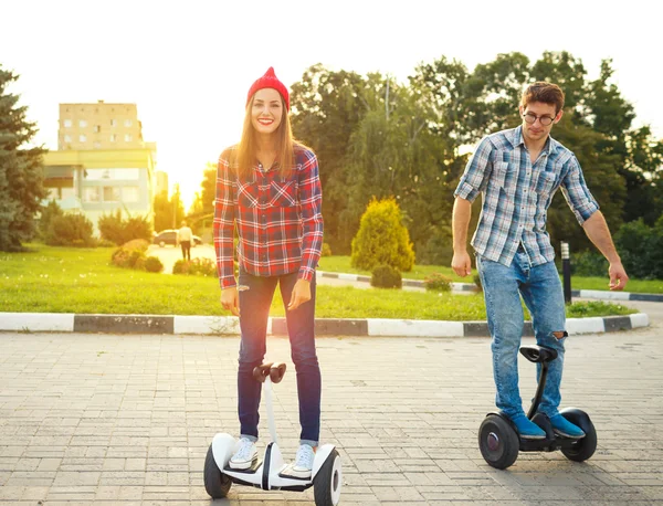 Jong koppel paardrijden hoverboard — Stockfoto