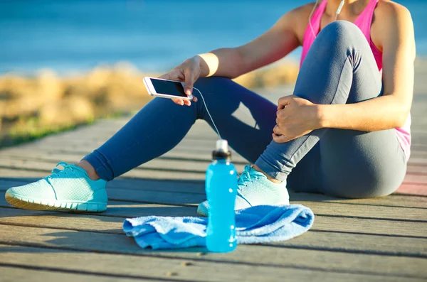 Mujer atlética descansando después de correr en el entrenamiento de la mañana por —  Fotos de Stock