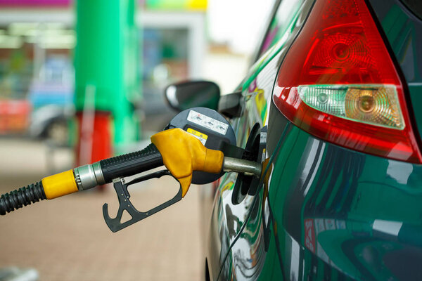 Car refueling on a petrol station close up