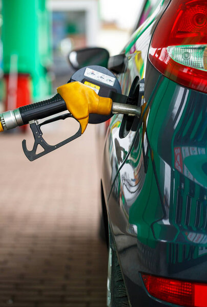 Car refueling on a petrol station close up
