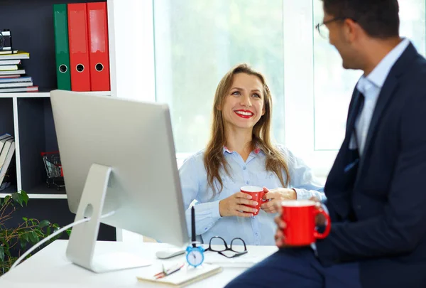 Beautiful young woman and man working from home office — Stock Photo, Image