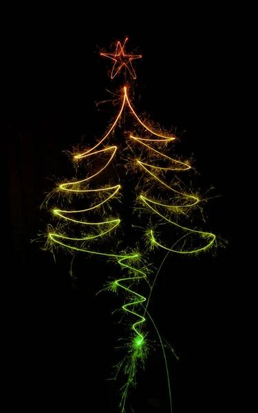 Kerstboom gemaakt door sparkler op een zwart — Stockfoto