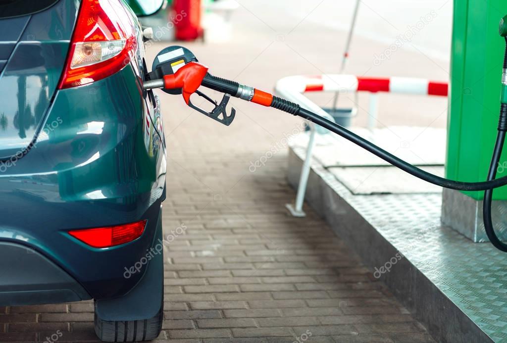 Car refueling on a petrol station close up
