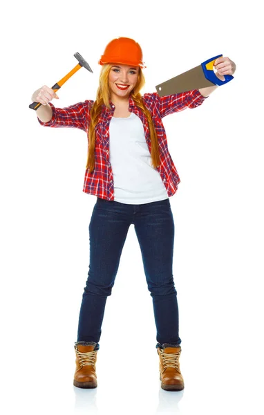 Young woman in helmet with a saw and hammer on a white — Stock Photo, Image