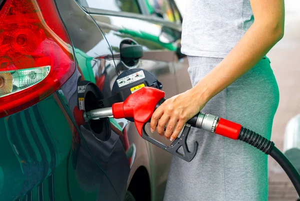 Femme remplit l'essence dans la voiture à une station-service — Photo