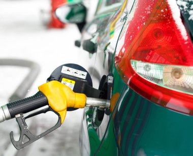 Bir benzin istasyonunda kışın yakıt ikmali araba