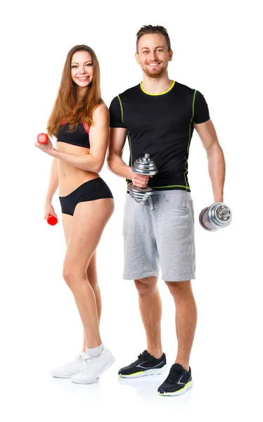 Homem atlético e mulher com halteres no branco — Fotografia de Stock