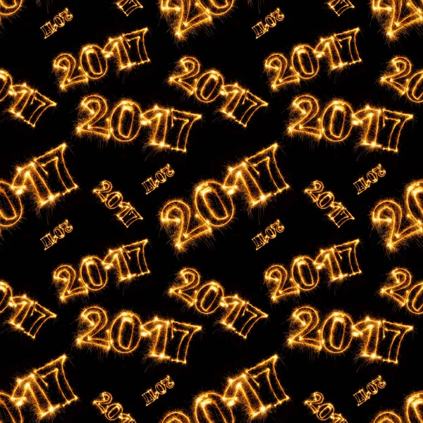 Seamless pattern of 2017 with sparklers on black background