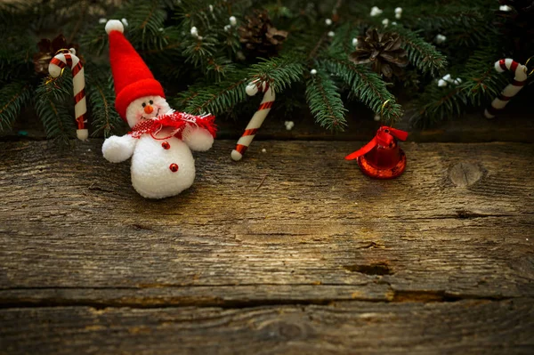 Christmas tree branches with christmas decorations and snowman o — Stock Photo, Image