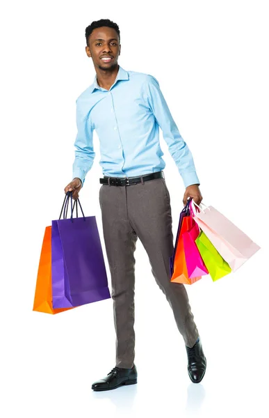Happy african american man holding shopping bags on white backgr — Stock Photo, Image
