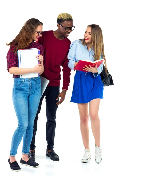 Three happy students standing and smiling with books — Stock Photo, Image