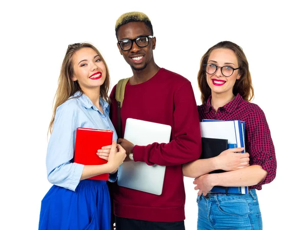 Three happy students standing and smiling with books — Stock Photo, Image