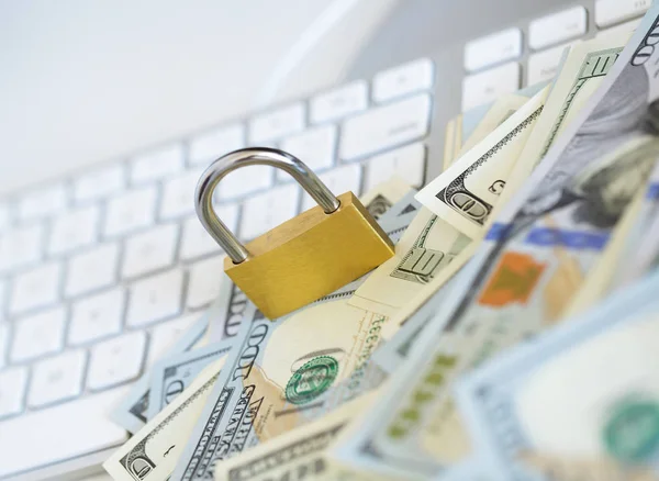 Security lock on dollar bills with white computer keyboard — Stock Photo, Image