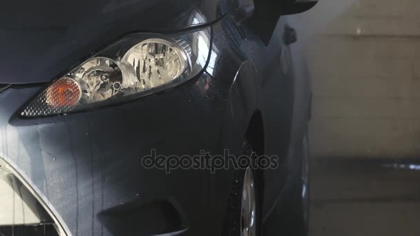 Car washed by hand using a water jet wash — Stock Video