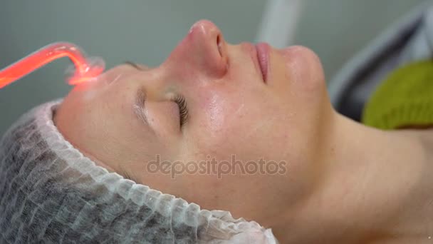 Receiving electric darsonval facial massage procedure — Stock Video