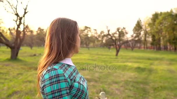 Woman blowing soap bubbles outdoors — Stock Video