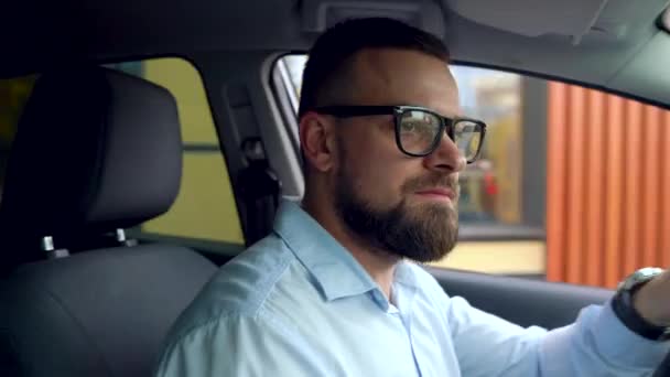 Barba hombre en un coche después de recibir su pedido en un restaurante de comida rápida — Vídeo de stock