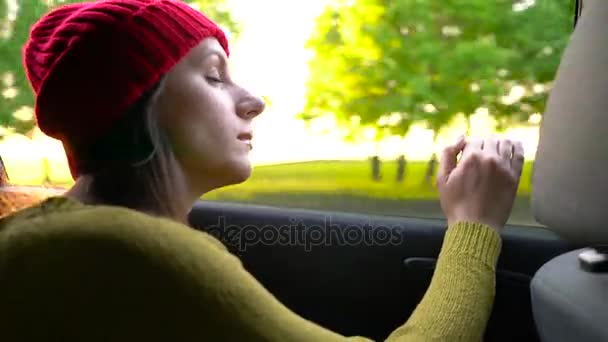 Ευτυχισμένος νεαρή γυναίκα κάθεται στο κάθισμα επιβάτη και κοιτάζοντας από το παράθυρο ηλιόλουστη ημέρα — Αρχείο Βίντεο