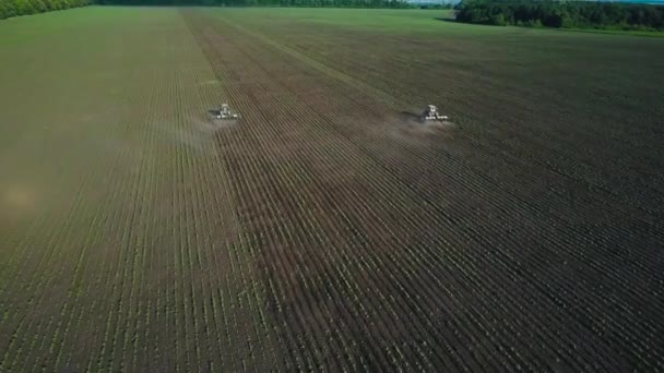 Two tractors performs seeding on the field — Stock Video