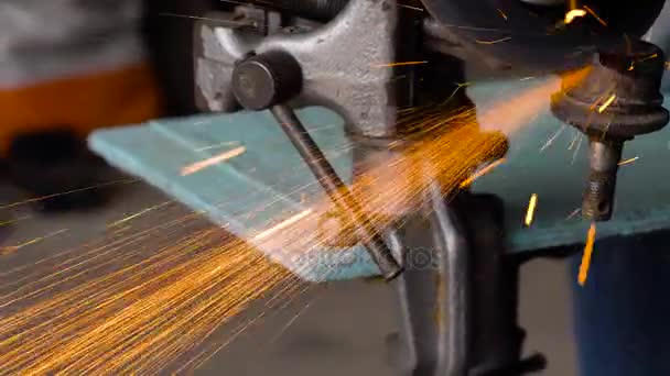 Worker with angular grinding machine is cutting the metal — Stock Video
