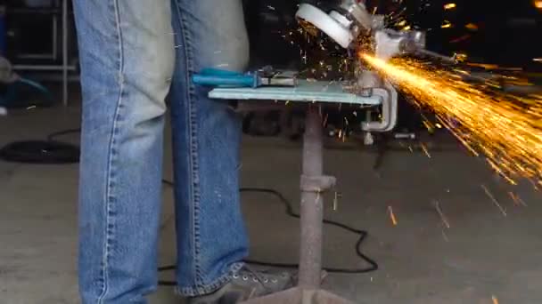 Male worker with angular grinding machine is cutting the metal. Slow motion — Stock Video