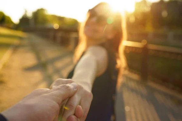 Follow me - happy young woman pulling guy's hand - hand in hand — Stock Photo, Image