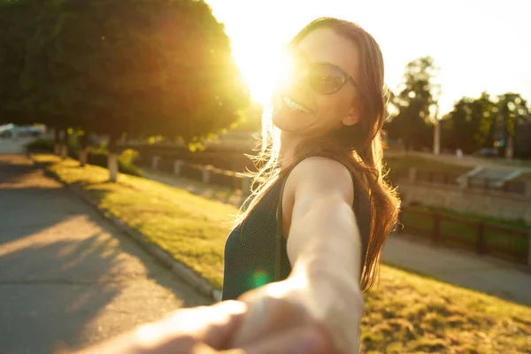 Follow me - happy young woman pulling guy's hand - hand in hand — Stock Photo, Image