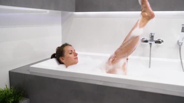 La mujer se relaja y toma un baño con espuma — Vídeos de Stock