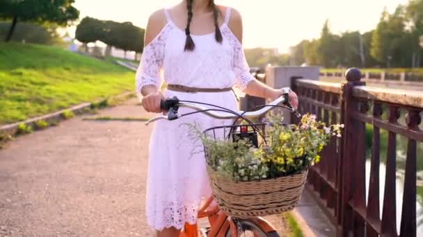 Fiatal gyönyörű nő, lovaglás kerékpár naplementekor — Stock videók