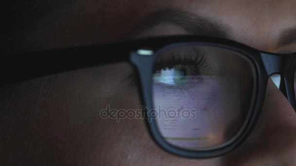 Woman in glasses looking on the monitor and surfing Internet — Stock Video