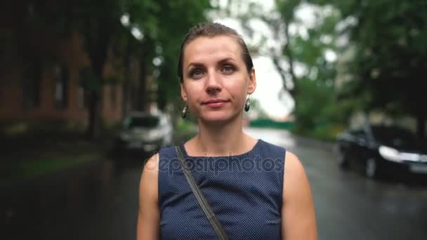 Γυναίκα που περπατά κάτω από την οδό μετά από μια βροχή, close-up πορτρέτο — Αρχείο Βίντεο