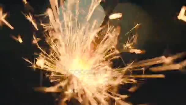 Christmas sparkler burning on a black. Slow motion — Stock Video