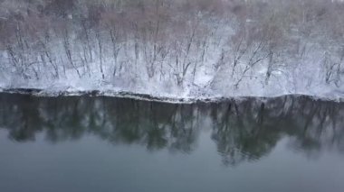 Uçuş orman ve nehir kıyısı boyunca sahilde kar ile kaplı