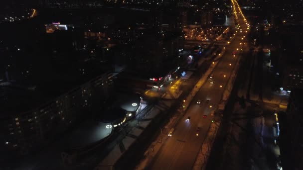 Blick von der Höhe auf die beleuchteten vielbefahrenen Straßen und nächtlichen, mehrstöckigen Häuser. Ukraine — Stockvideo