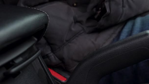 Male hand fastening car safety seat belt while sitting inside of vehicle before driving — Stock Video