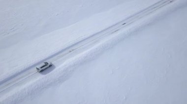 Karla kaplı alanlar arasında kış orman yolu sürüş araba havadan görünümü