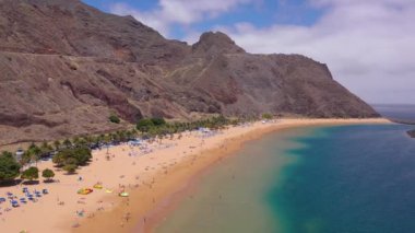 Altın kumların tepesinden, palmiye ağaçlarından, güneş pansiyonlarından, Las Teresitas, Tenerife, Kanarya, İspanya sahillerindeki tanınmayan insanlardan