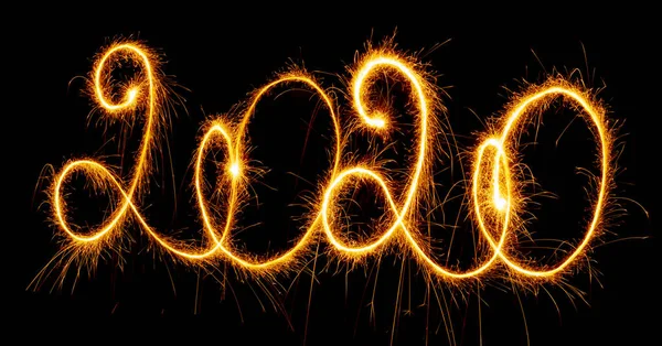 Happy New Year 2020 with sparklers on black background — Stok Foto