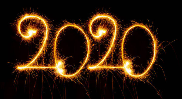 Happy New Year 2020 with sparklers on black background Royalty Free Stock Images