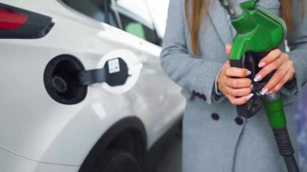 Mulher enche gasolina em seu carro em um posto de gasolina close-up. Movimento lento — Vídeo de Stock