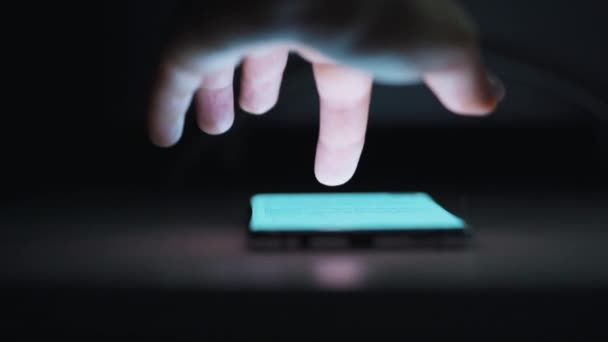 Hand using smartphone for surfing internet close-up at night — ストック動画