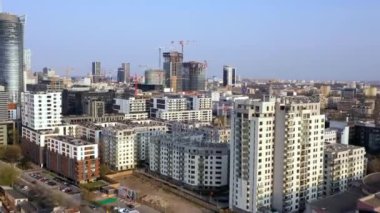 Warsaw, Poland - April 9, 2019: view from the height on downtown of Warsaw, buildings, construction cranes and traffic